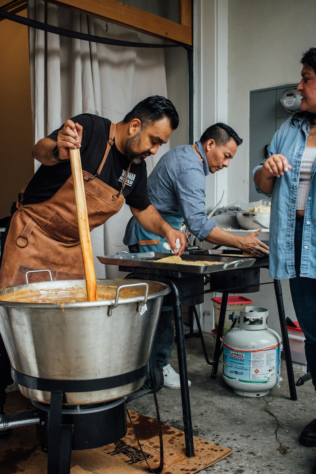 group cooking paella together