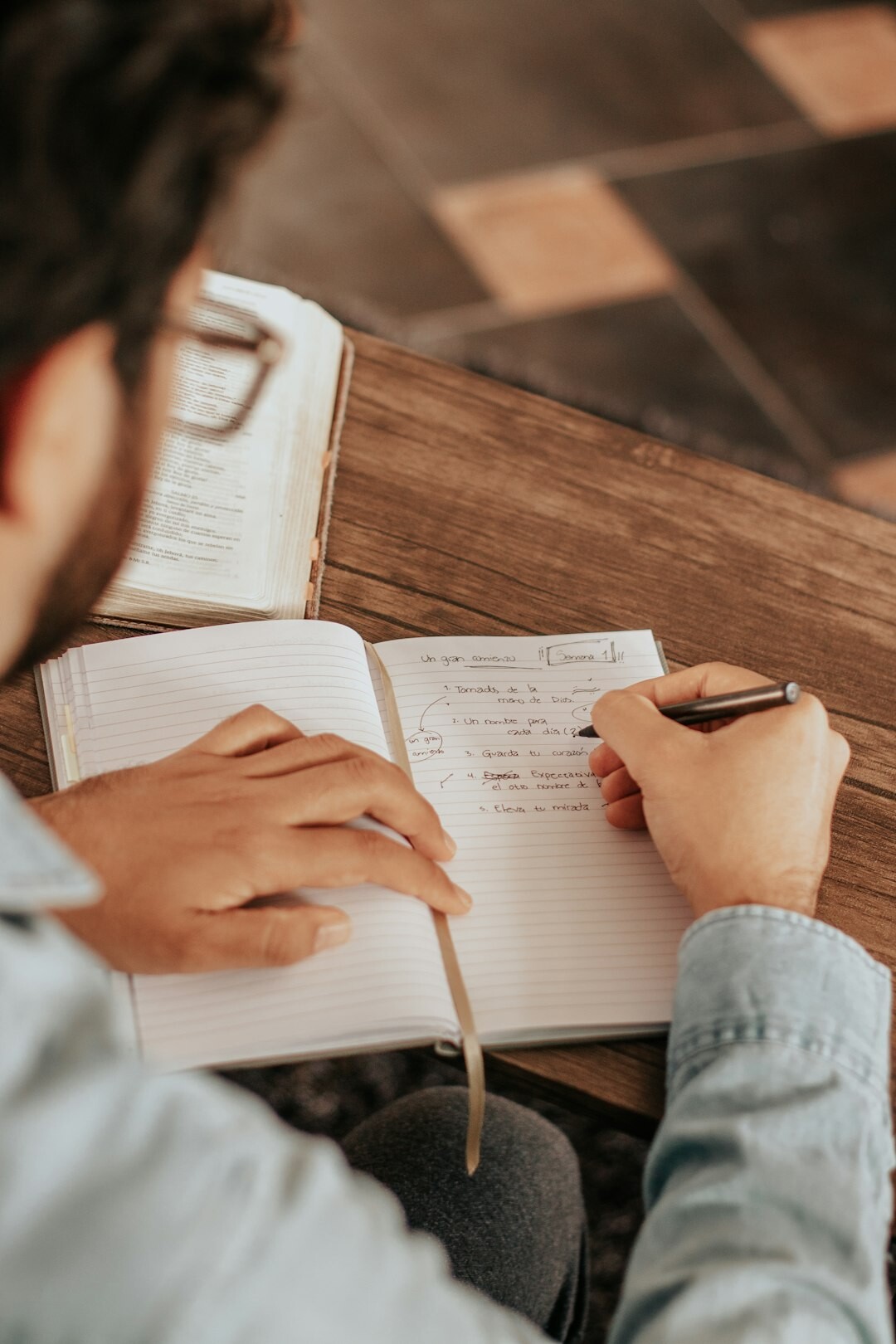 person learning spanish with notebook